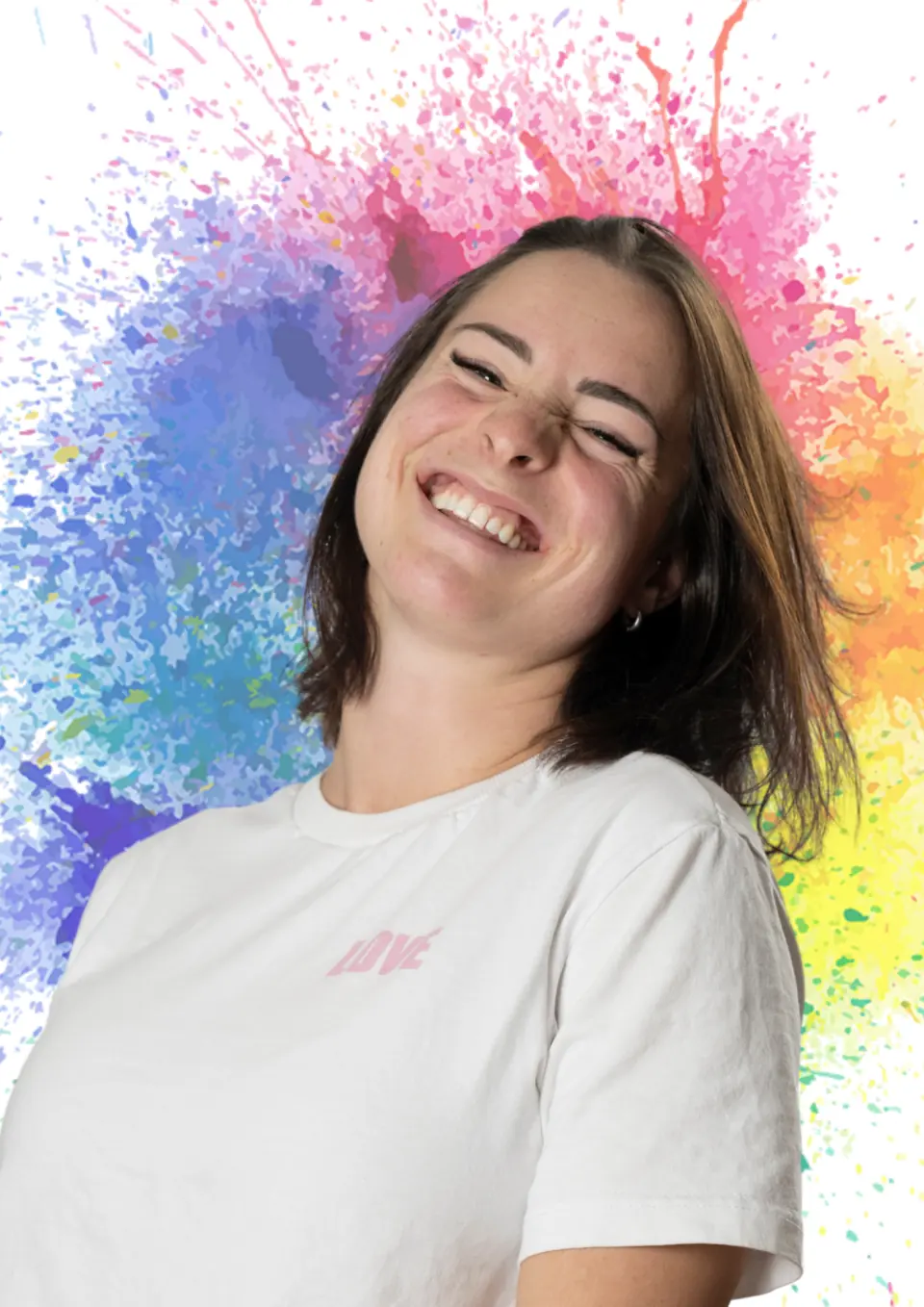 Julia Neumann laughing in front of a colourful paint splash